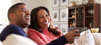 Couple watching tv in living room