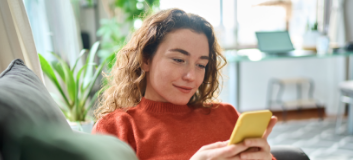 Lady browsing phone in living room