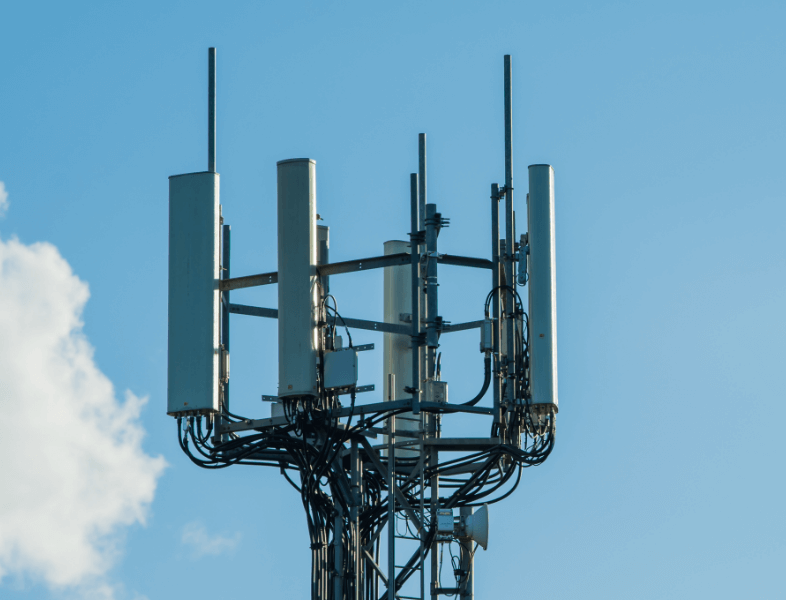 Copped version of the top of a telecommunications tower in front of a clear sky