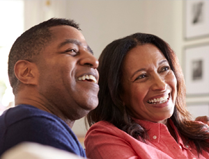 Couple watching tv in living room