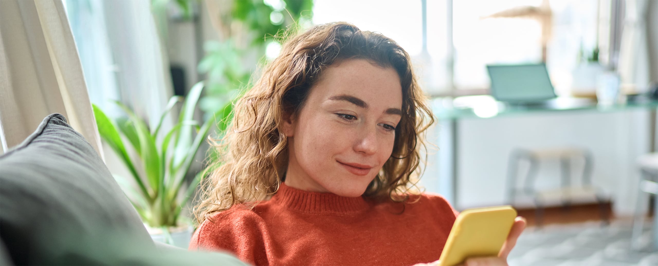 Lady browsing phone in living room