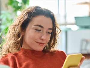 Lady browsing phone in living room